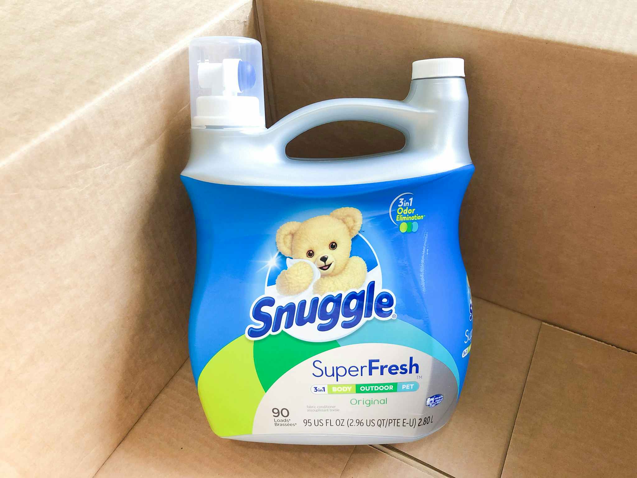 A Snuggle fabric softener bottle in an open delivery box.