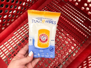 hand holding a pack of arm & hammer foot wipes at target