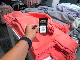 hand holding price tag on girls' hoodie at Target