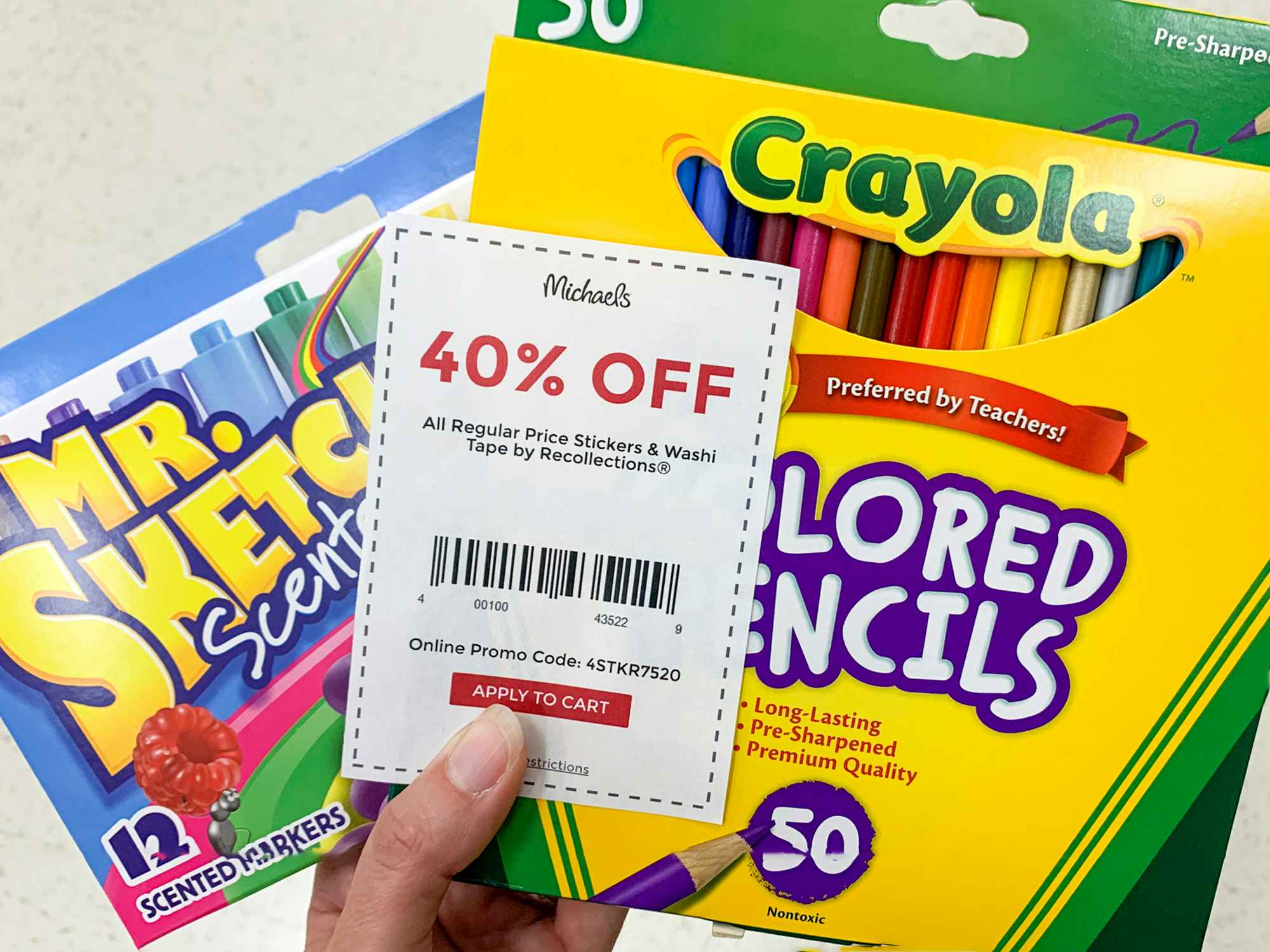 Scented markers and colored pencils held together with a michaels 40% off coupon
