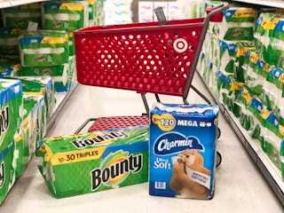 Packages of Bounty paper towels and Charmin bath tissue in front of Target shopping cart