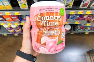 hand holding bottle of lemonade powder