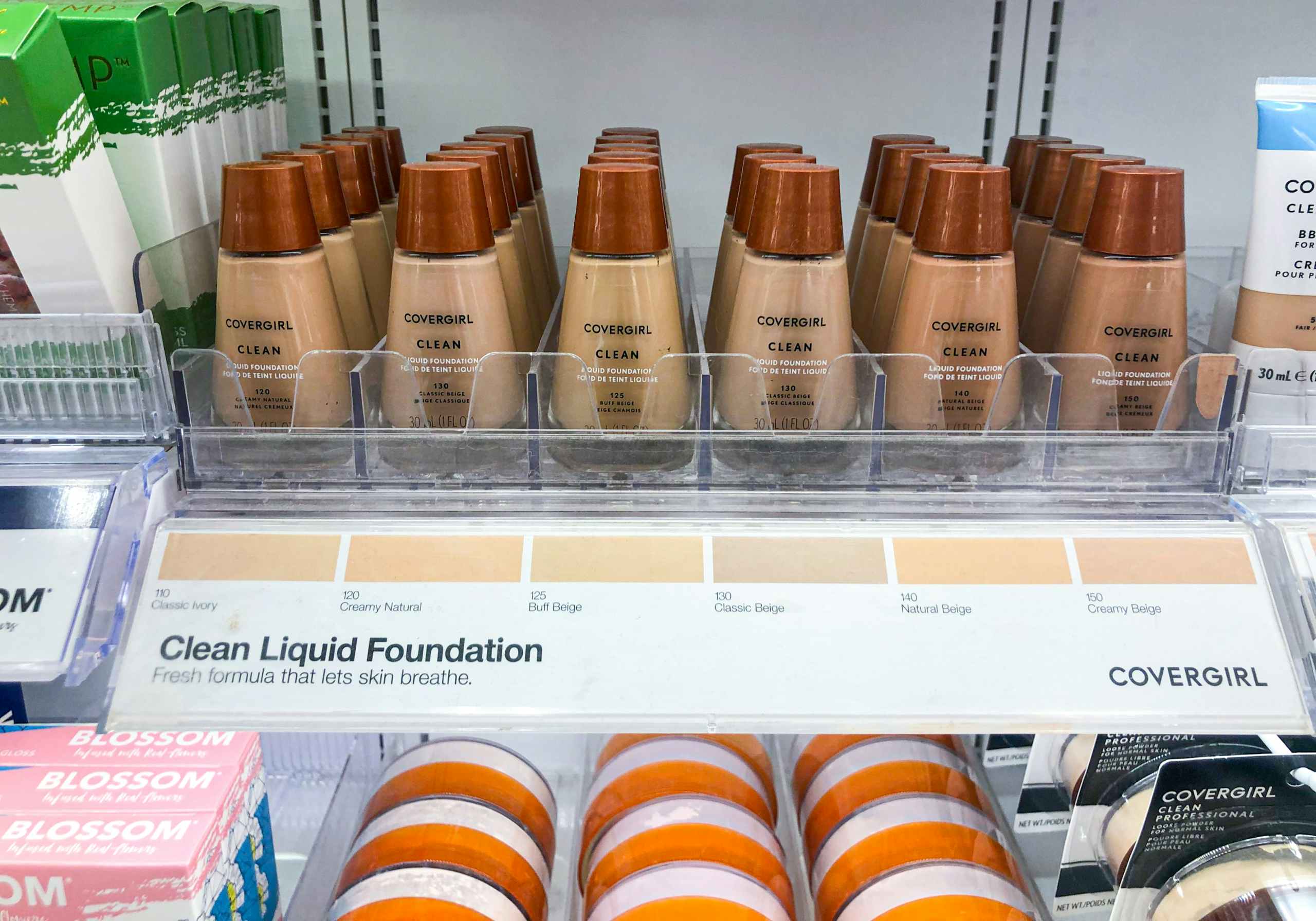 bottles of Covergirl liquid foundation on the shelf of a makeup aisle at Target