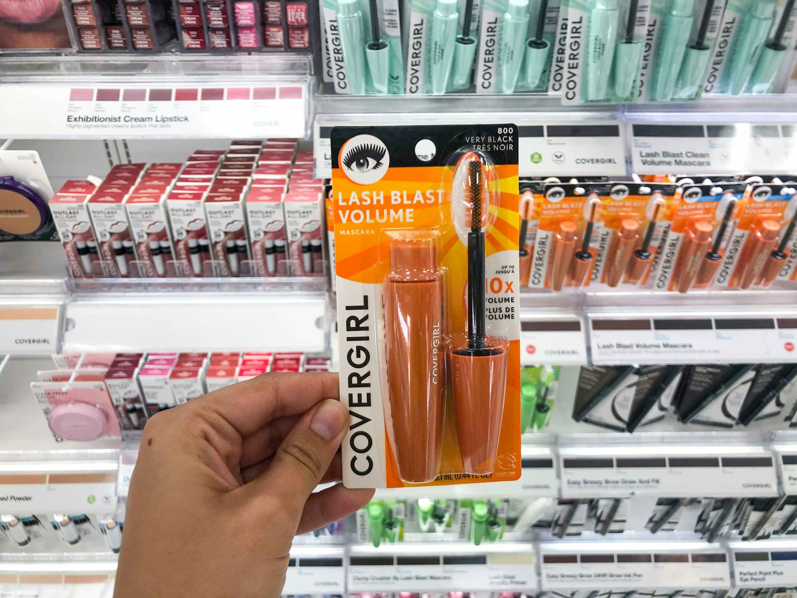 hand holding Covergirl mascare in makeup aisle at Target