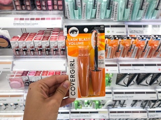 hand holding Covergirl mascare in makeup aisle at Target