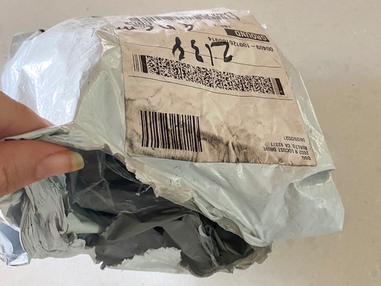 A person opening a dicks sporting goods online order package