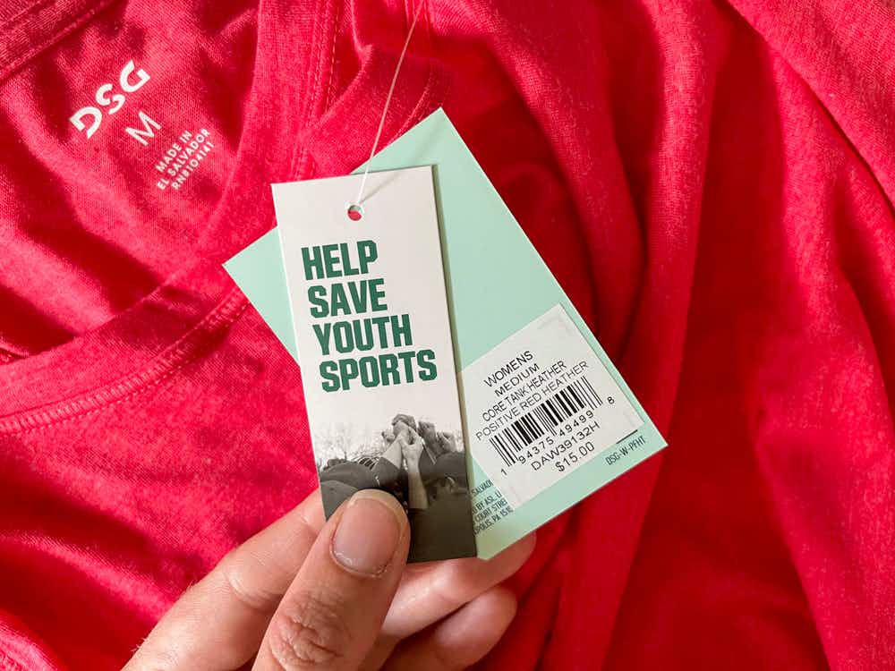 A close up of a DSG womens clothing price tag attached to a pink shirt from discks sporting goods