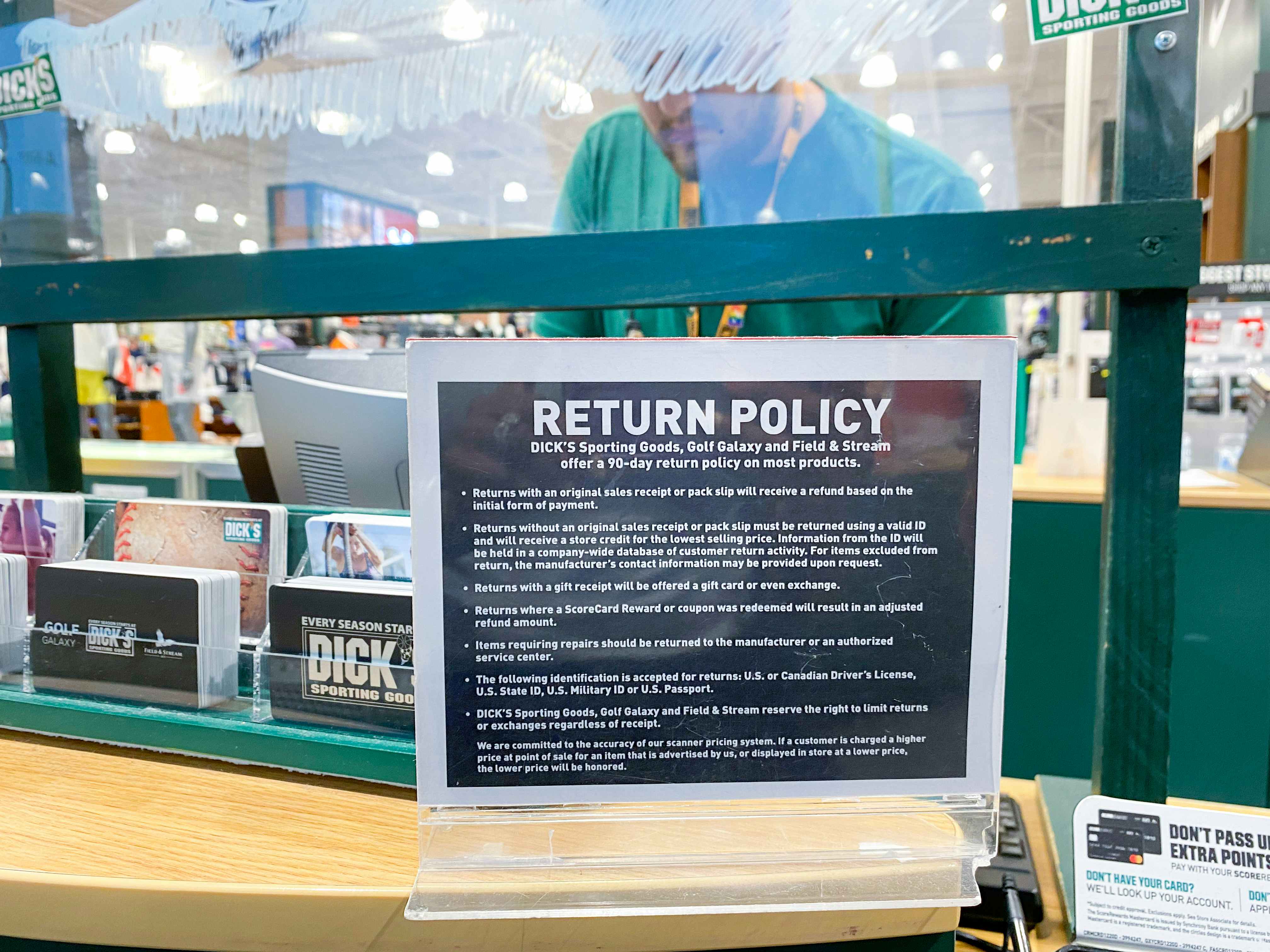 return policy sign at the checkout counter in dicks sporting goods