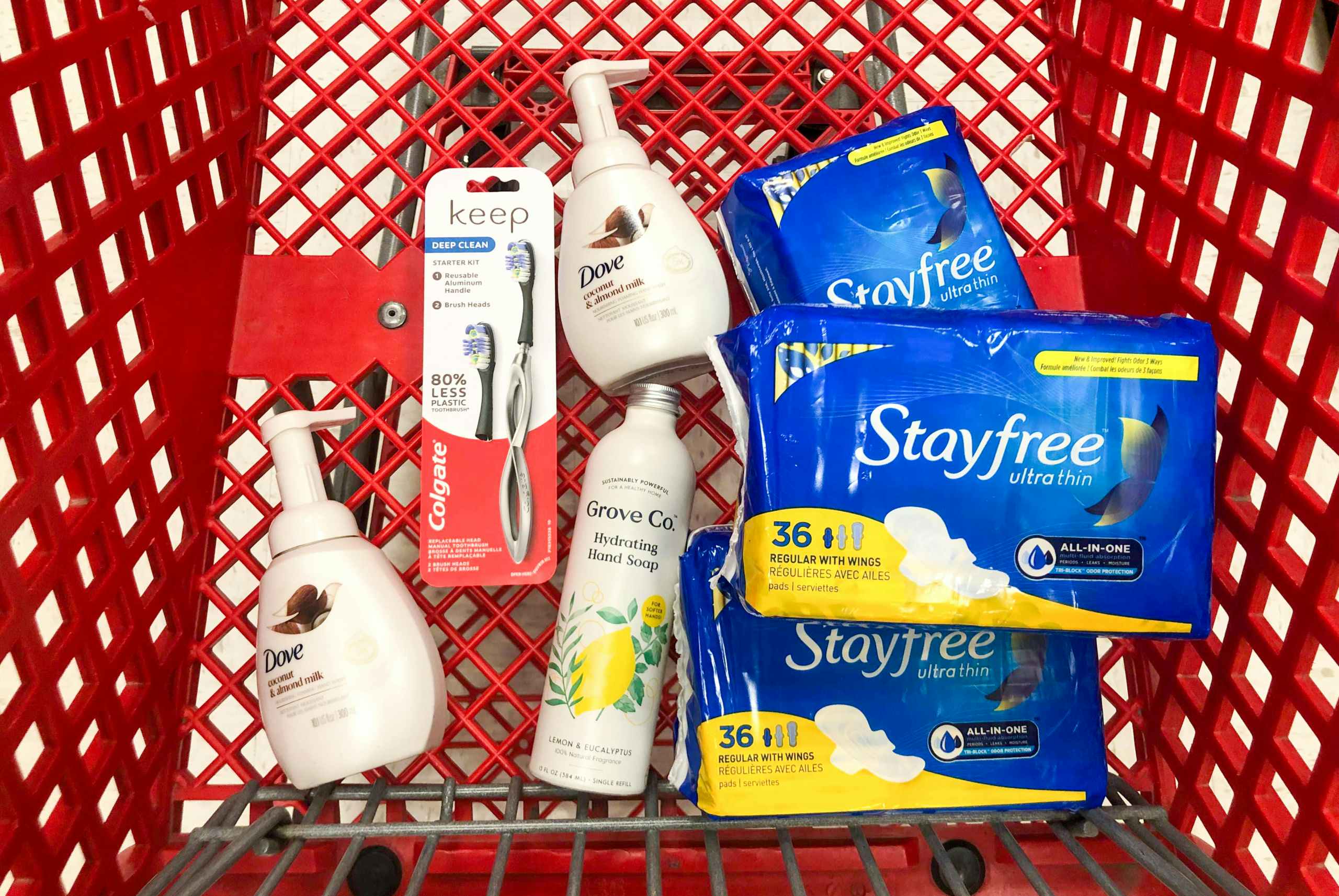 bottles of soap, a toothbrush, and pads in Target shopping cart