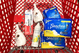 bottles of soap, a toothbrush, and pads in Target shopping cart