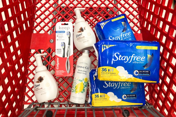bottles of soap, a toothbrush, and pads in Target shopping cart