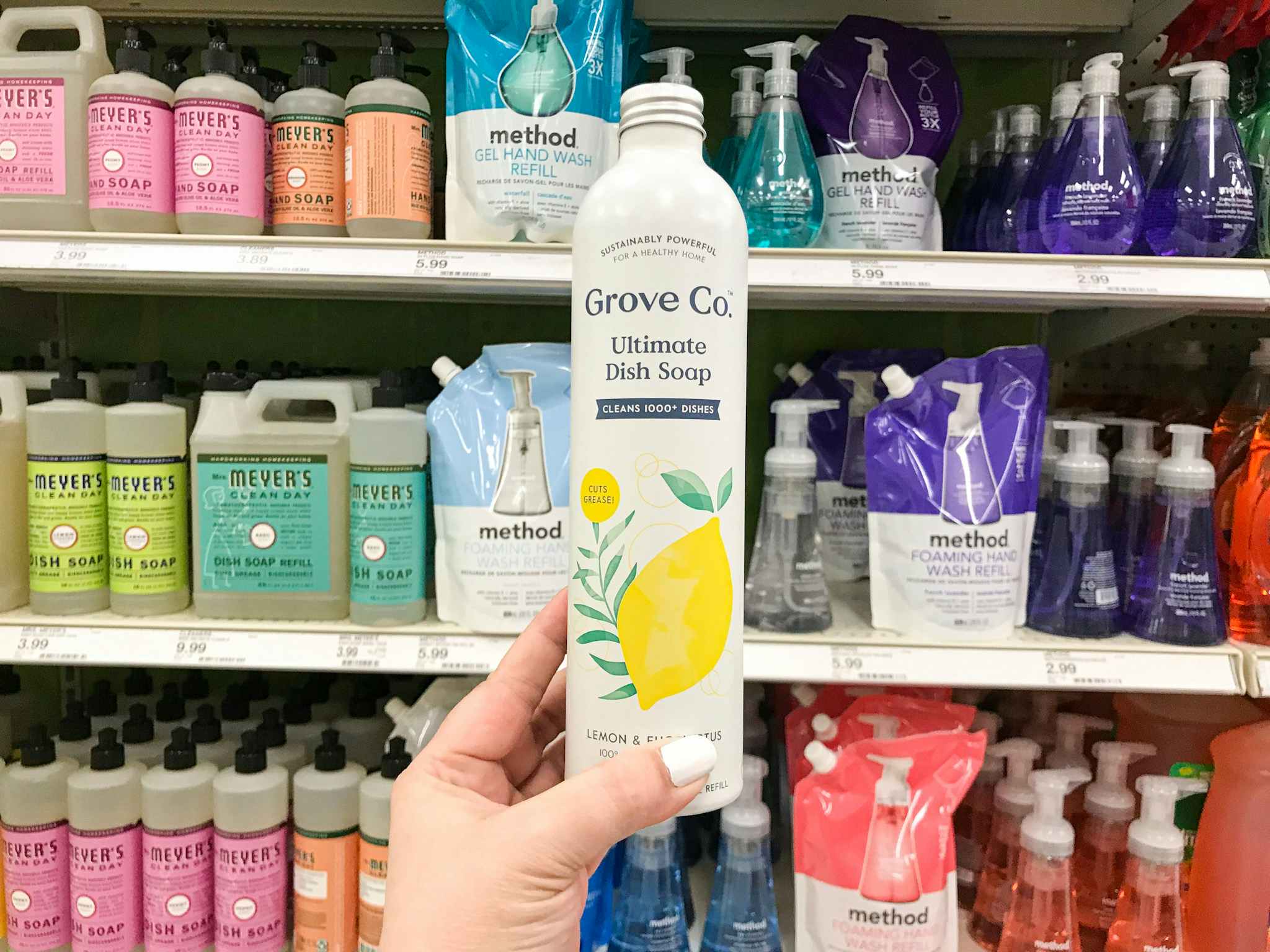 hand holding a bottle of grove co dish soap at target