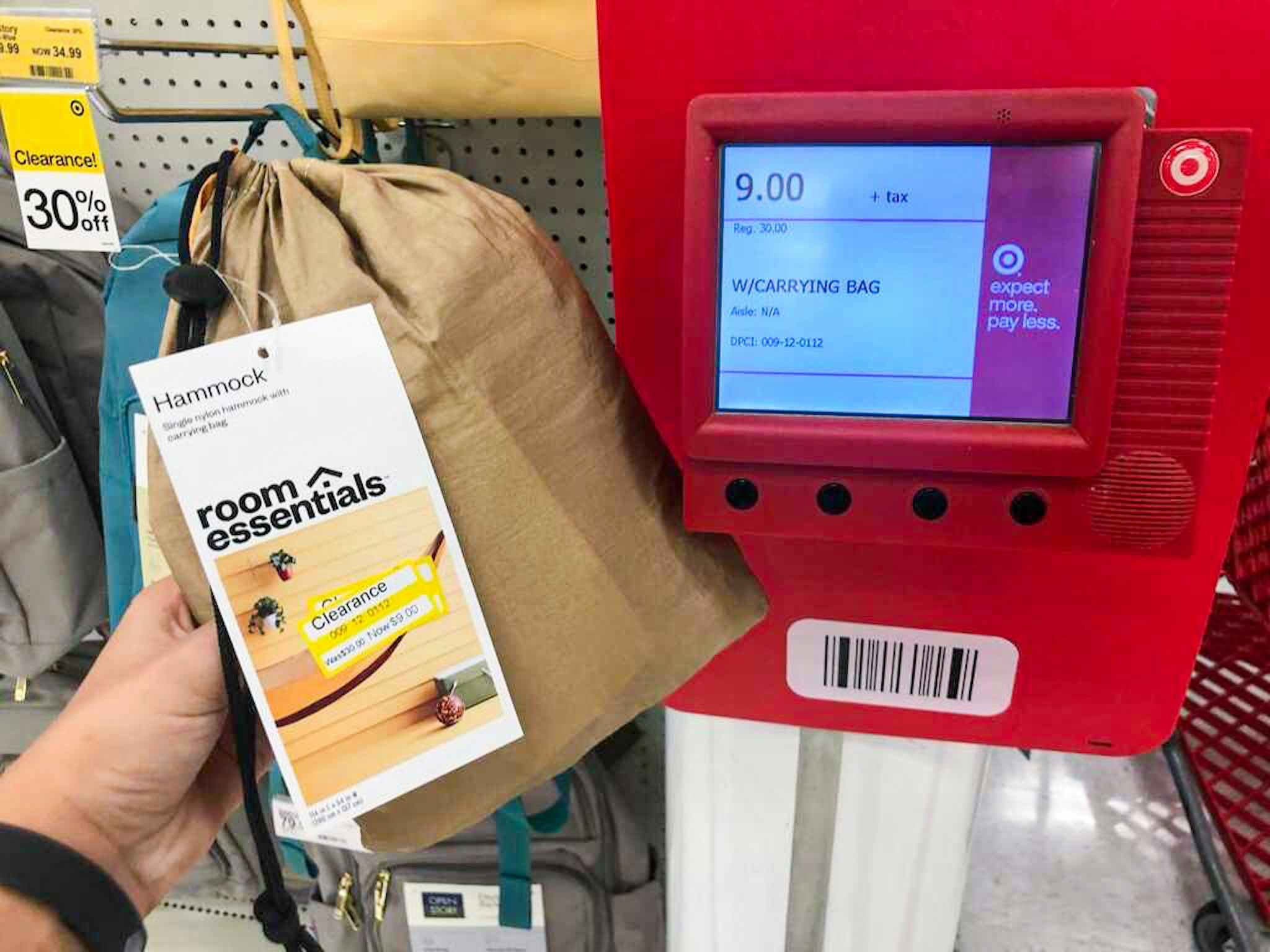 hand holding a room essentials hammock in front of a price checker