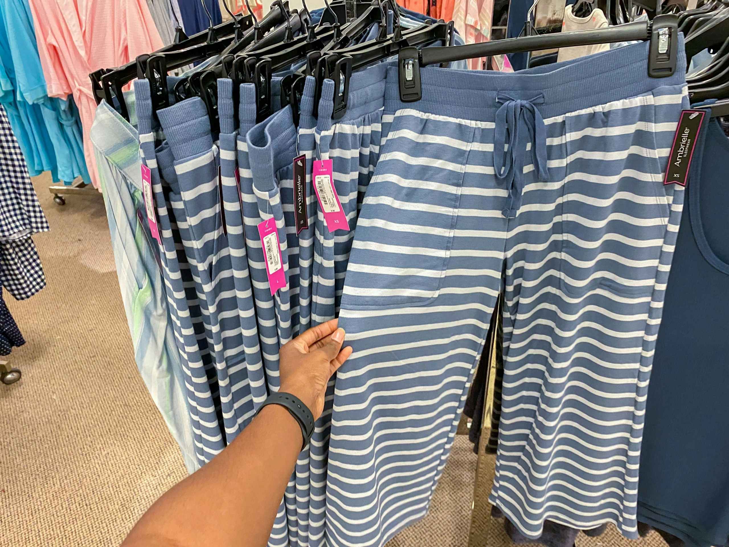 Hand holding women's pajama pants