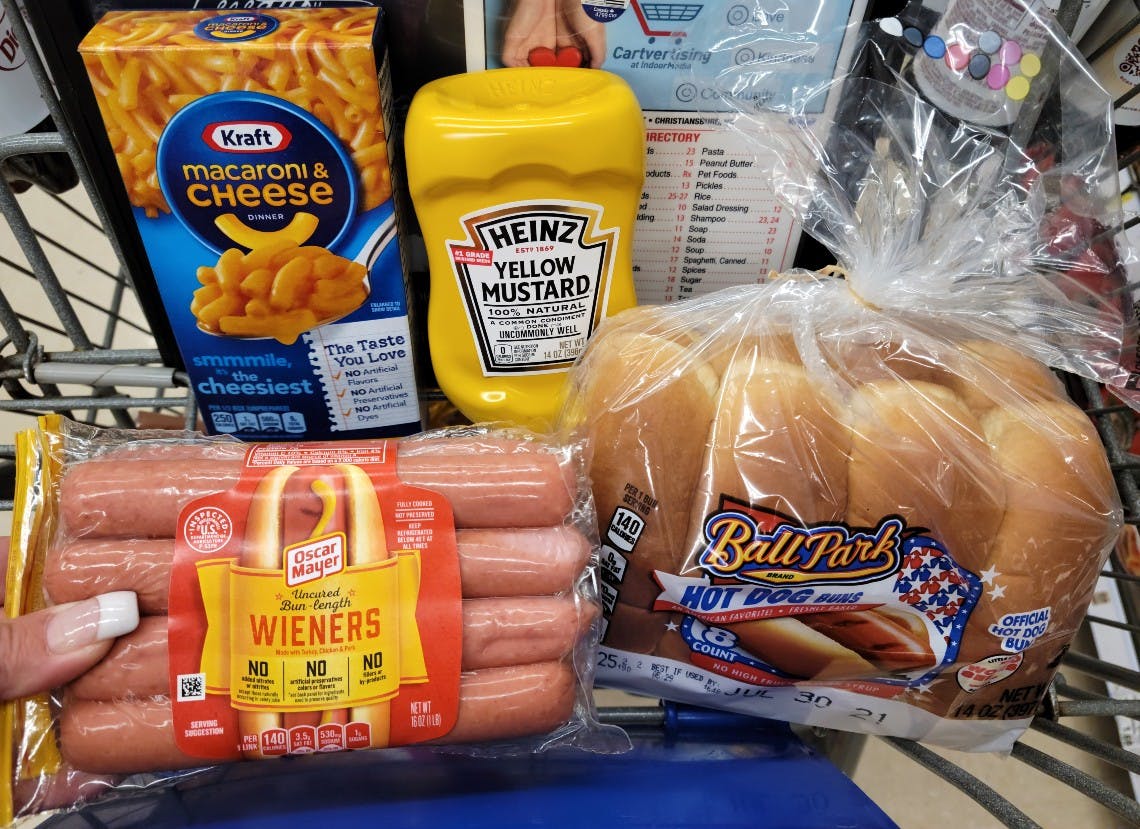hotdogs, buns, mustard and macaroni and cheese in cart