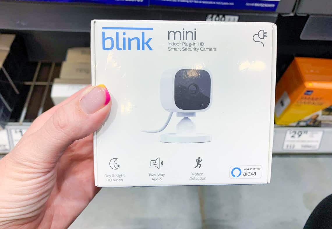 blink mini indoor security camera held in its box at home improvement store