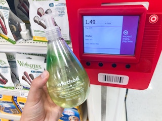 hand holding bottle of Method soap in front of clearance scanner at Target