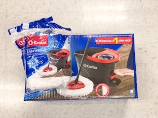 o ceder mop in box with two bags of mop head refills stacked on top of each other