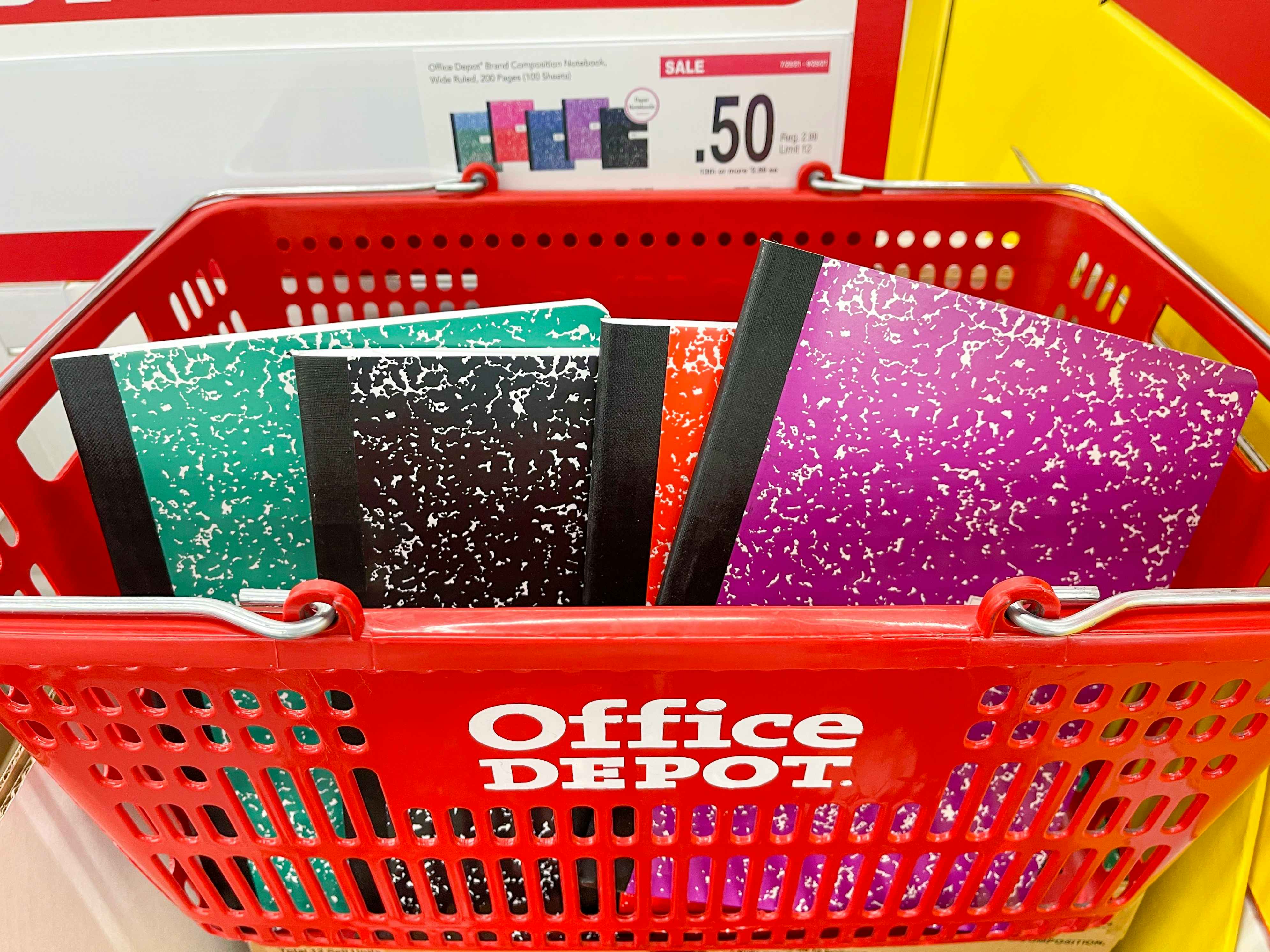 A red office depot basket full of notebooks.