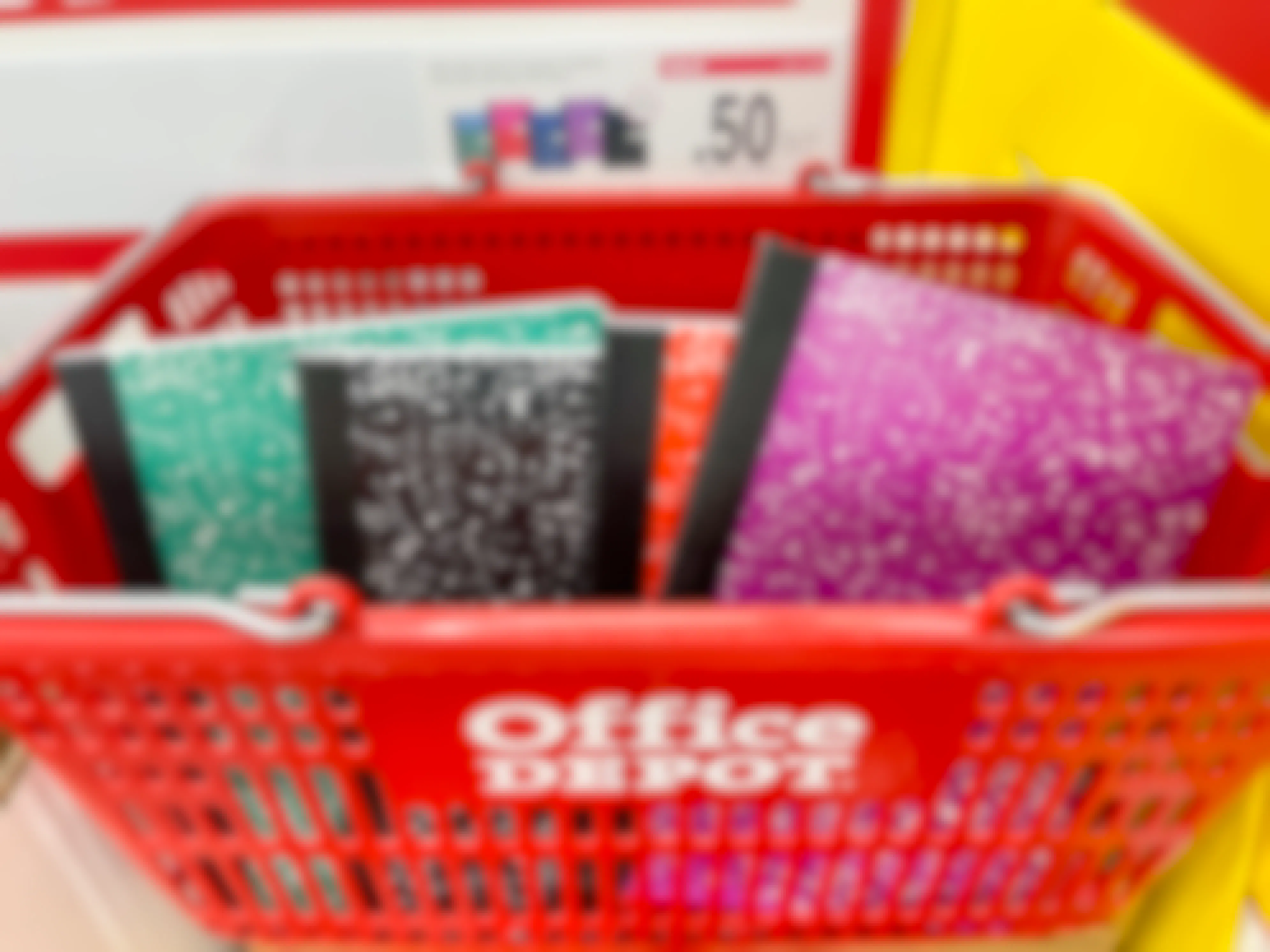 A red office depot basket full of notebooks.
