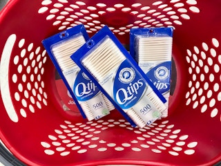 three boxes of q-tips cotton swabs in a target basket