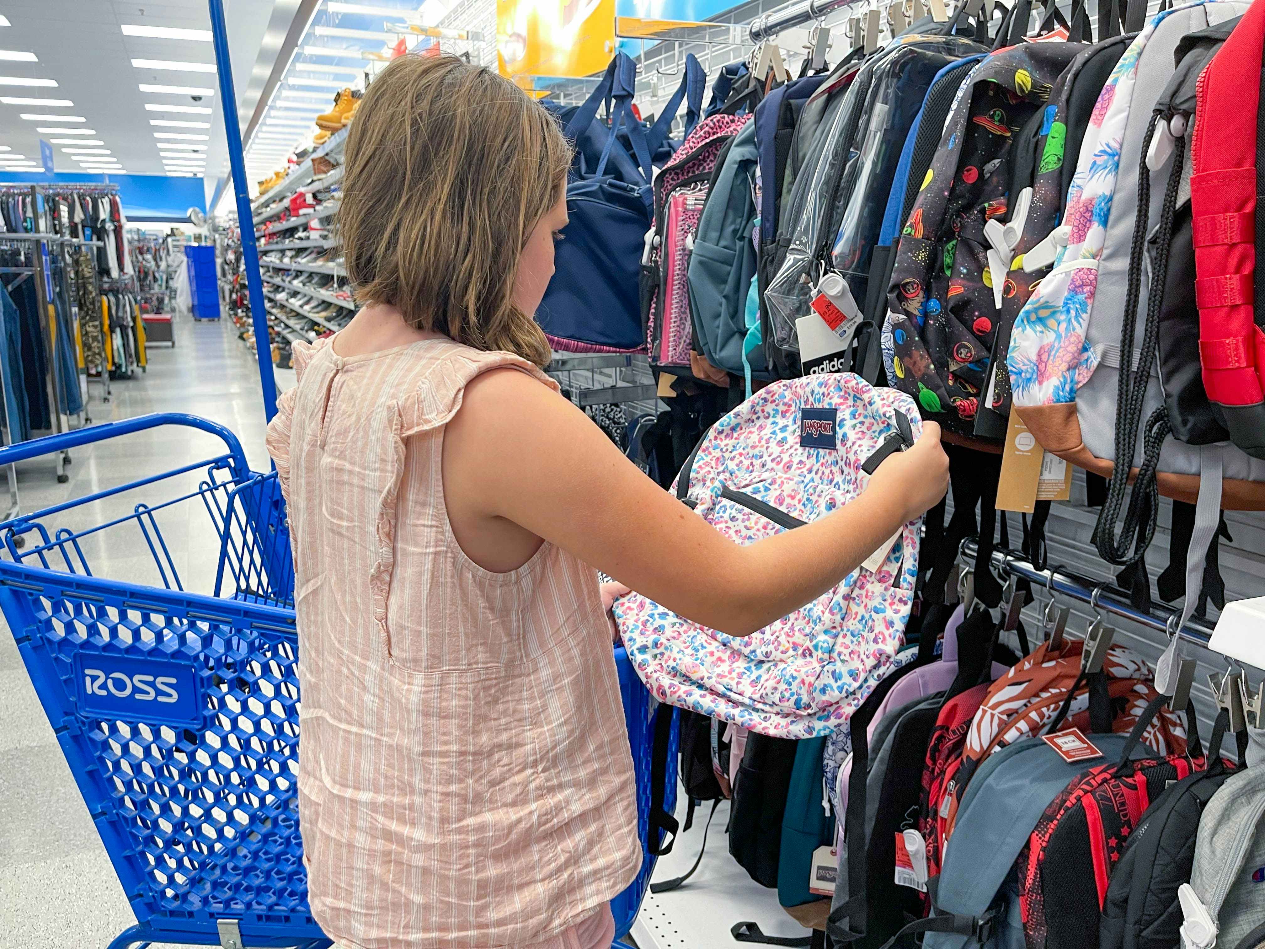 child shopping for backpacks at Ross Dress for less store