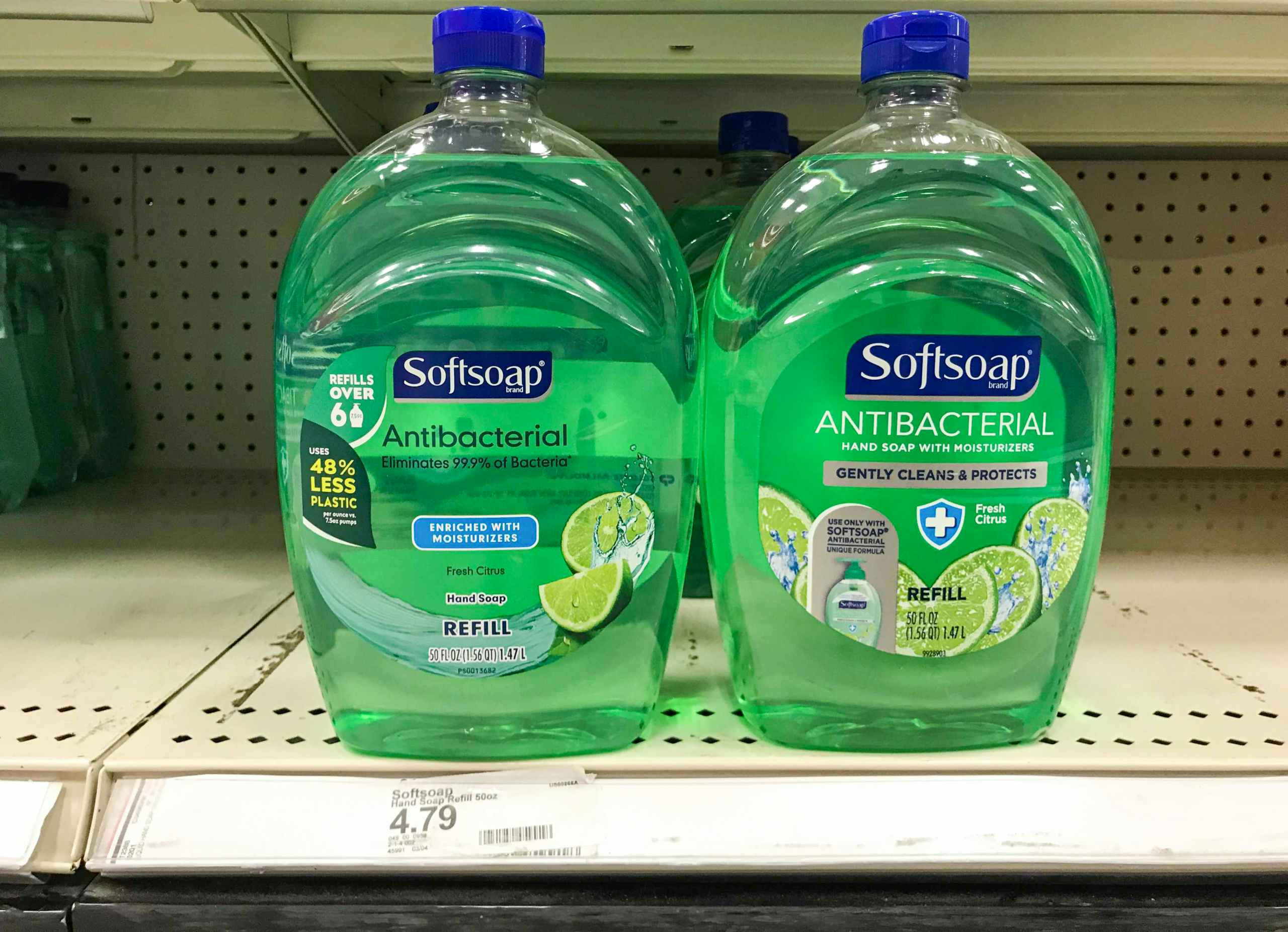 two bottles of Softsoap hand soap refills on store shelf
