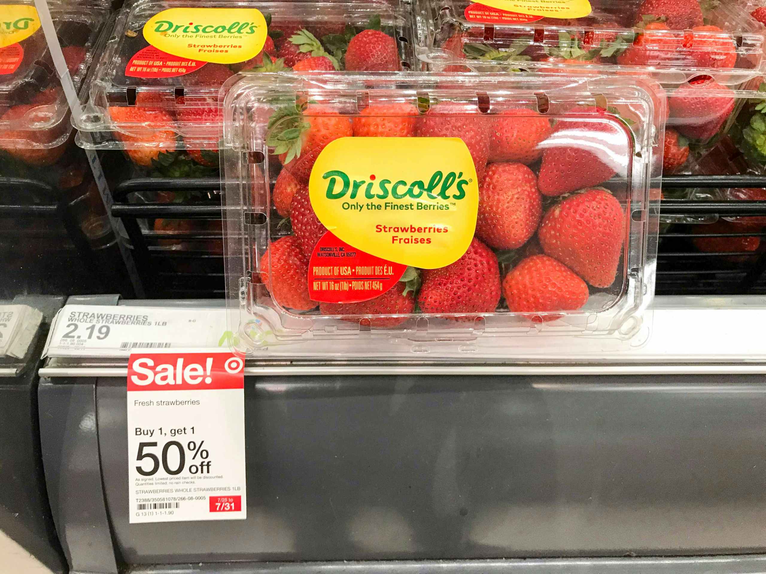 1-pound package of fresh strawberries in front of produce aisle and BOGO 50% off sign at Target