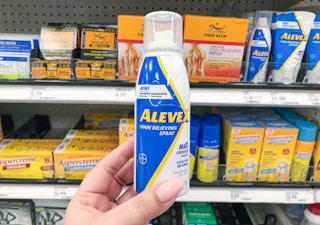 AleveX Pain Releiving Spray held in front of Target shelf