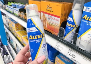 AleveX Pain Releiving Spray held next to price tag on Target shelf