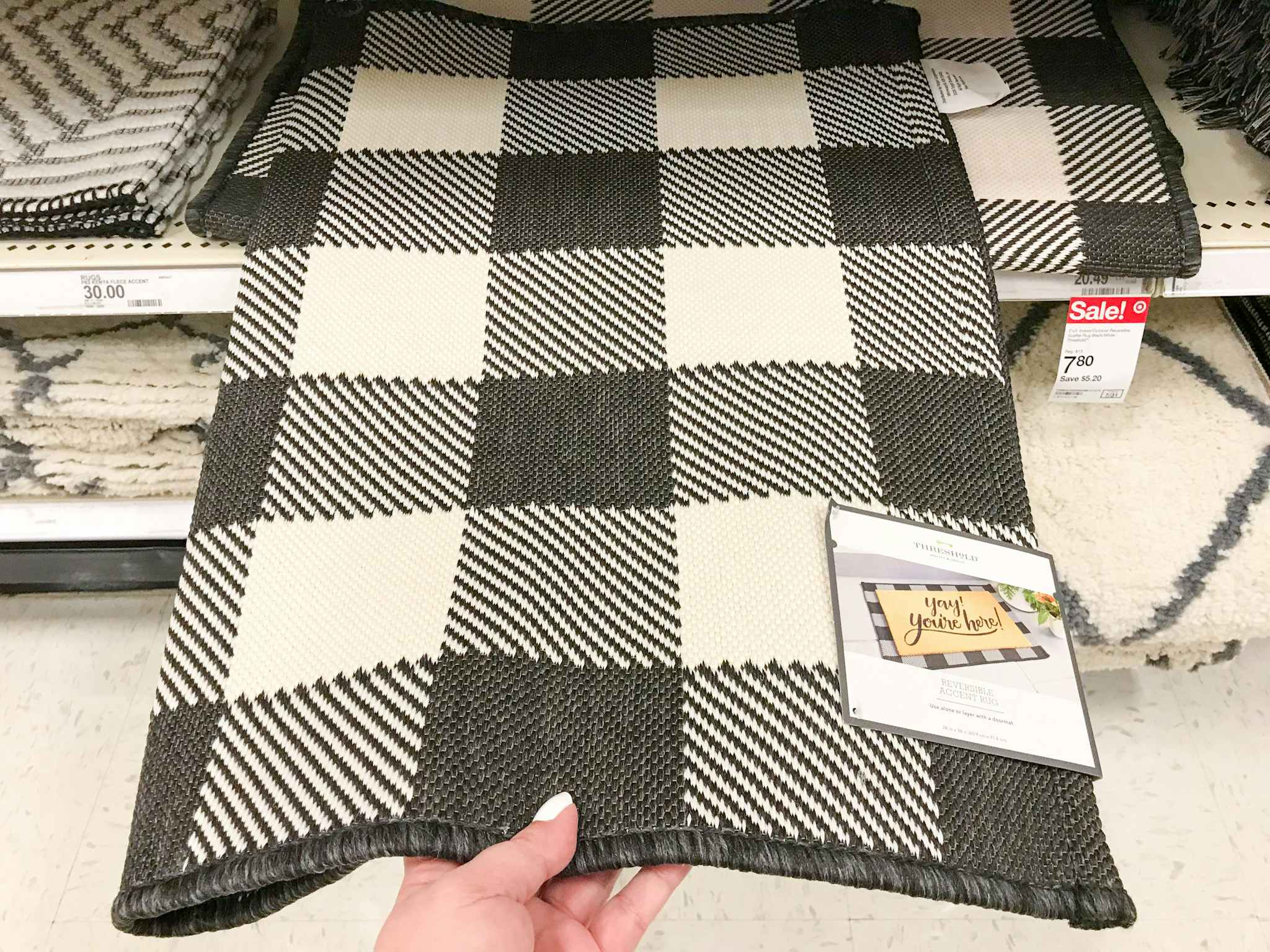 hand grabbing a threshold scatter rug at target