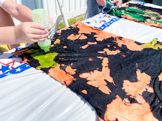 little boy adding tie dye to shirt