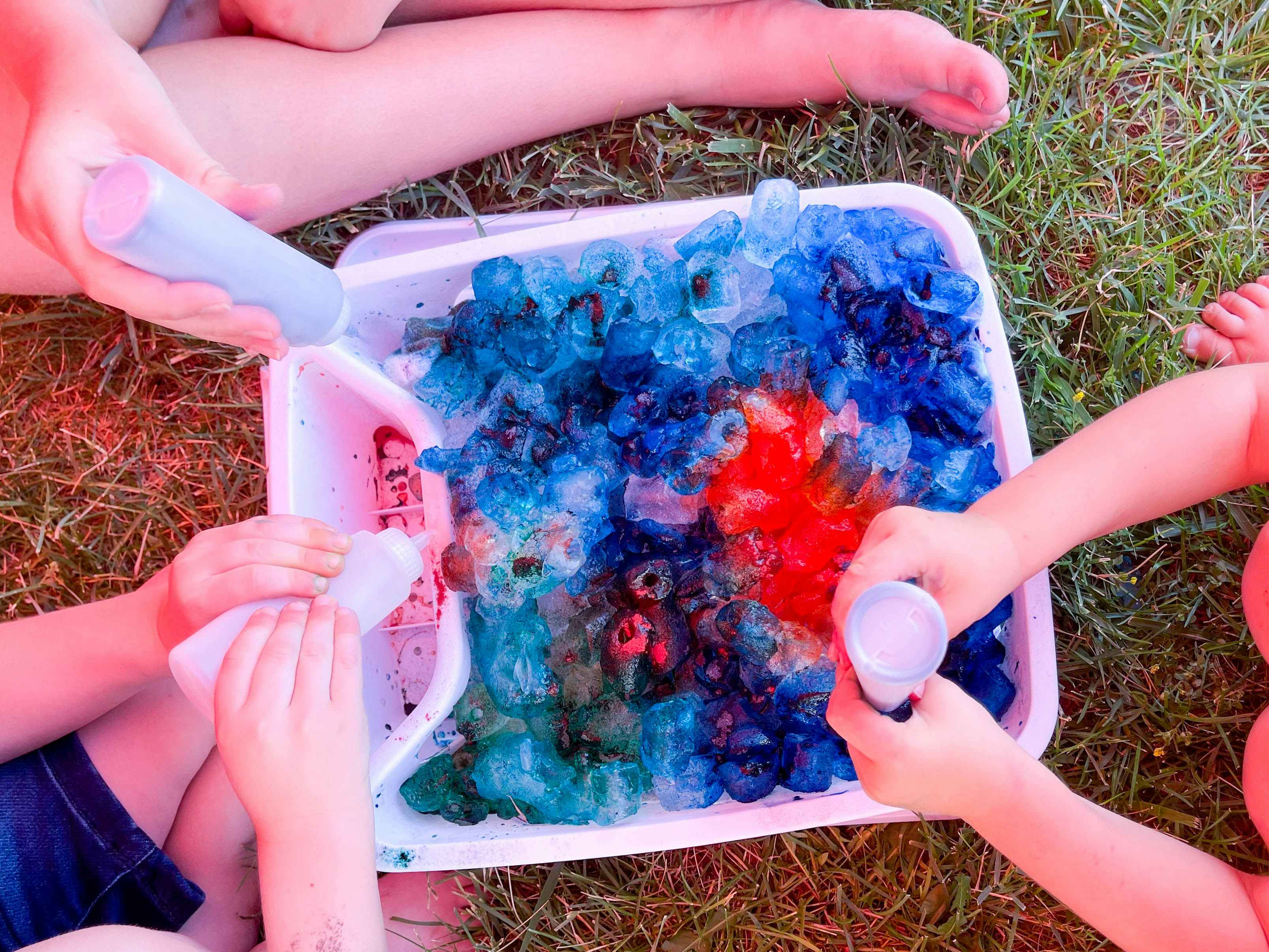 close up of kids making ice tie dye shirts