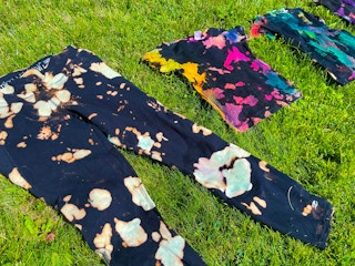 black and bleached tie dye clothes in grass