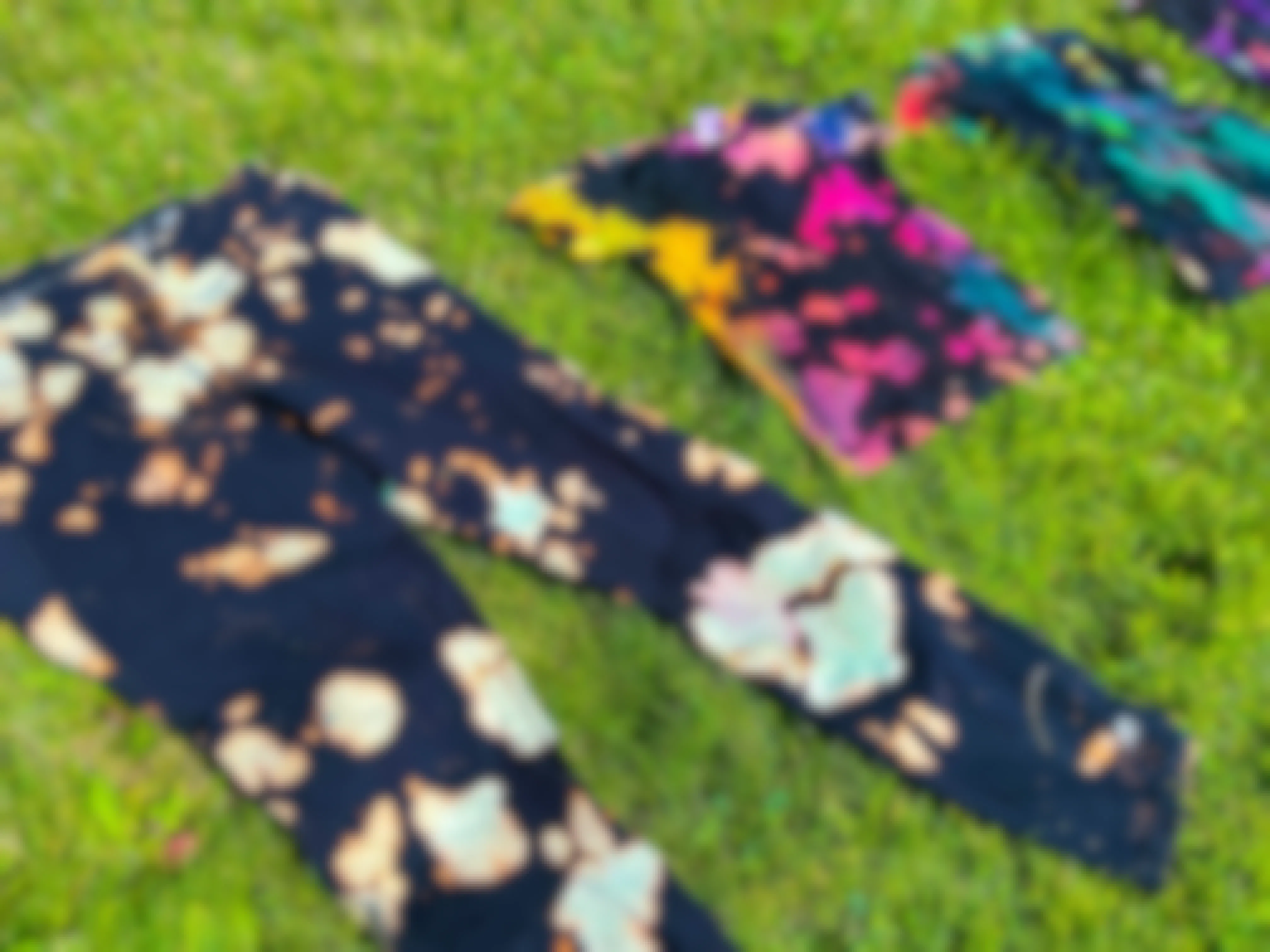 black and bleached tie dye clothes in grass