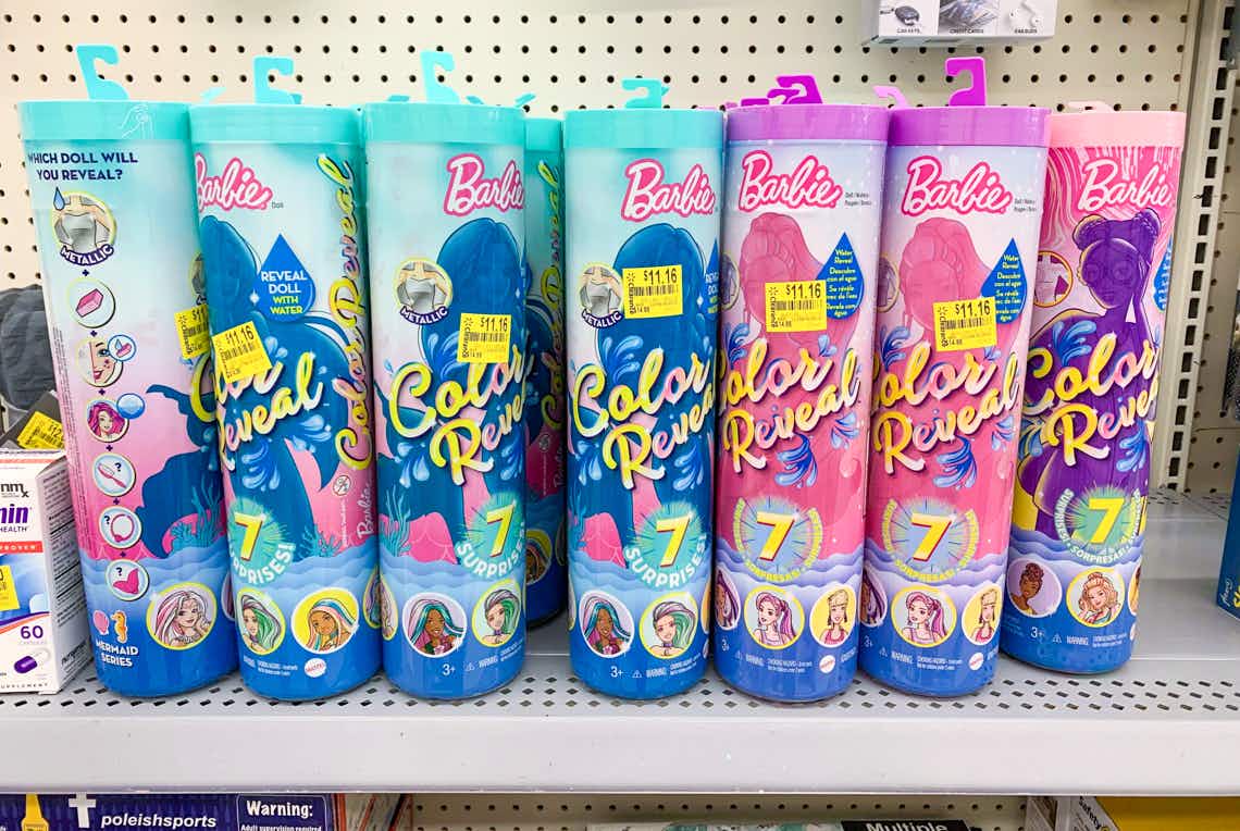 a bunch of barbie color reveal susprise doll tubes with clearance price tags on walmart shelf