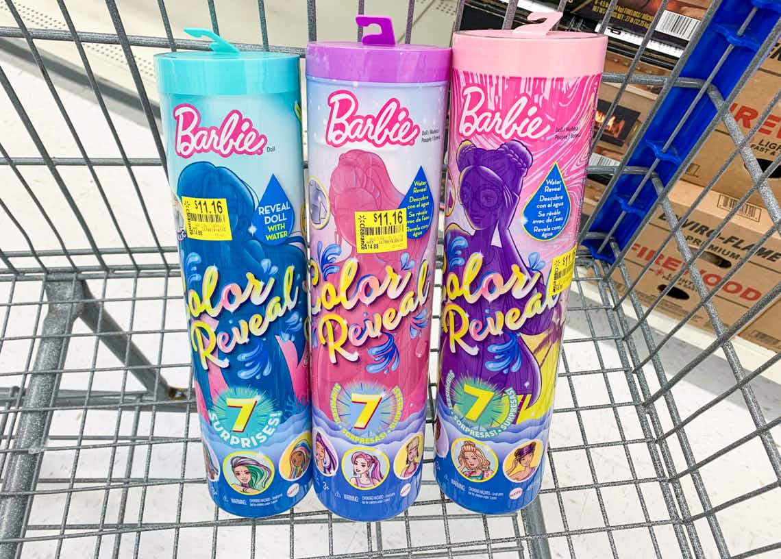 three barbie color reveal surprise mermaid dolls in tubes with clearance price tags in a walmart cart