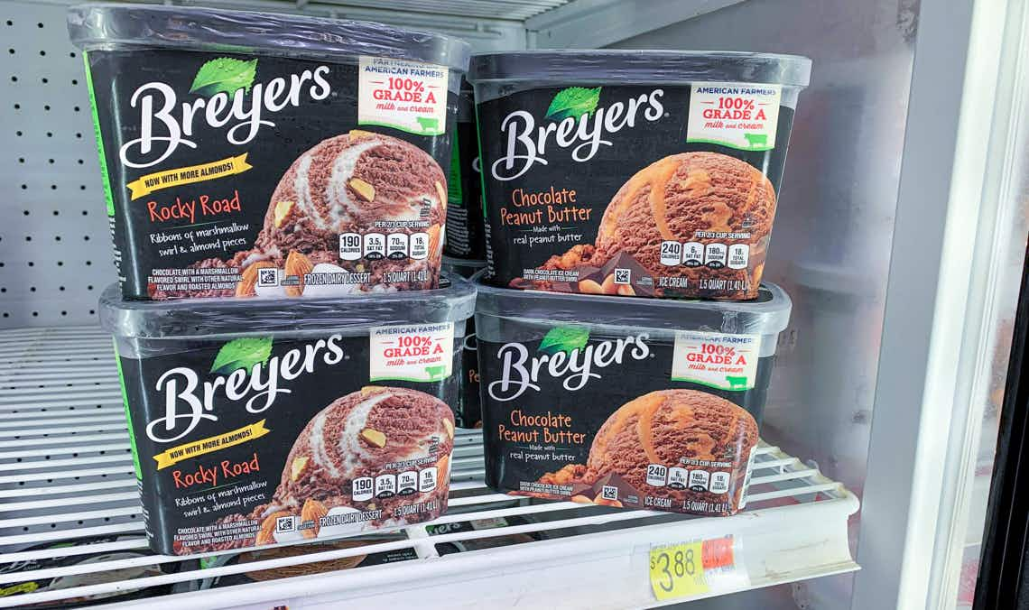 four containers of breyers ice cream on shelf in walmart freezer