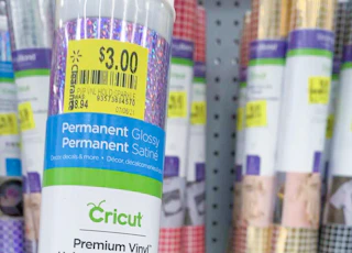close up of cricut vinyl clearance tag with other vinyl tubes in background