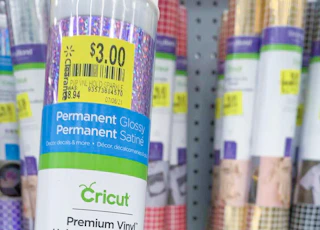 close up of cricut vinyl clearance tag with other vinyl tubes in background