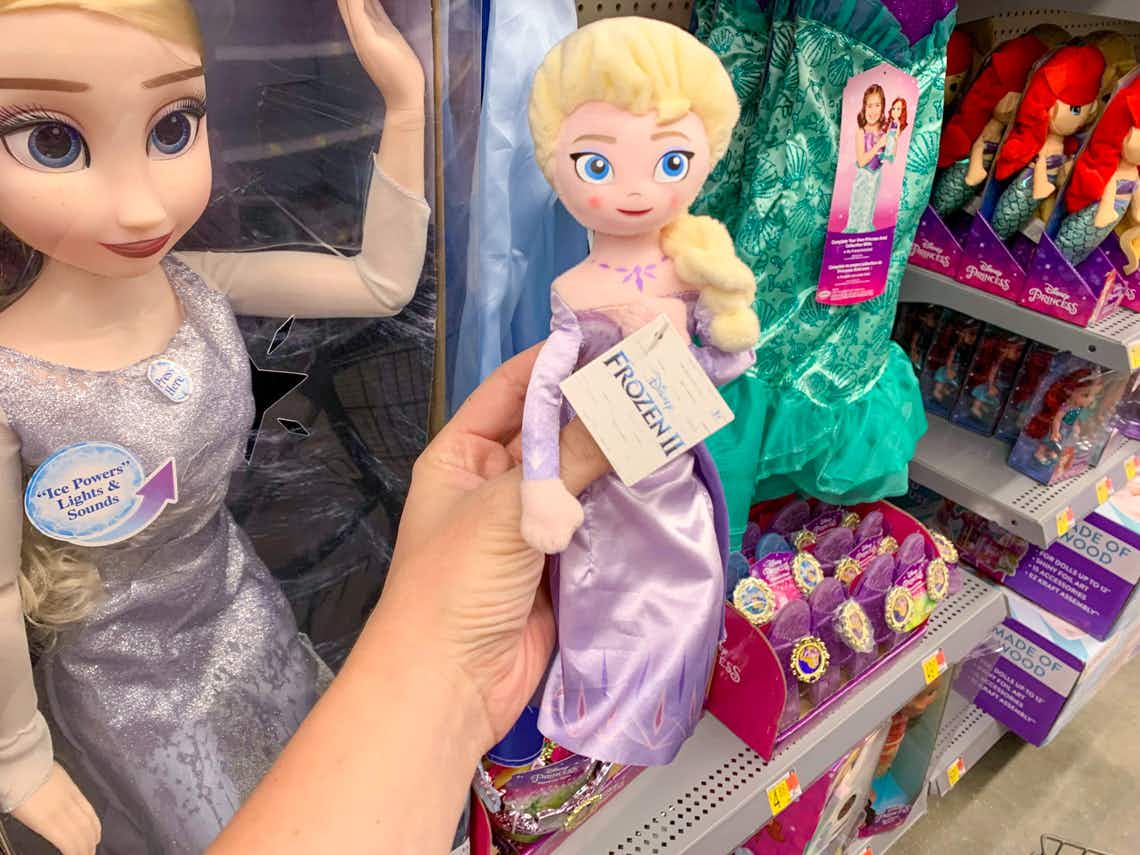 disney frozen II Elsa plush doll held in front of other Frozen toys