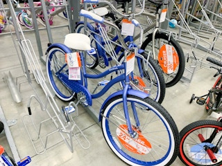 huffy cranbrook periwinkle cruiser adult bike in bike rack at walmart