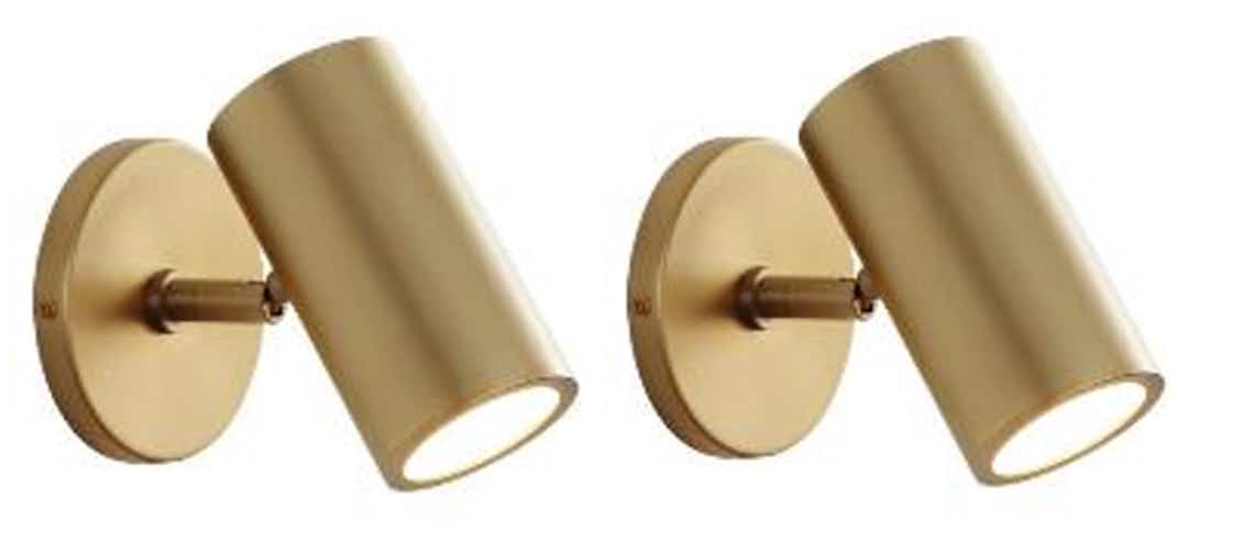 set of two modrn brass wall sconces on white background