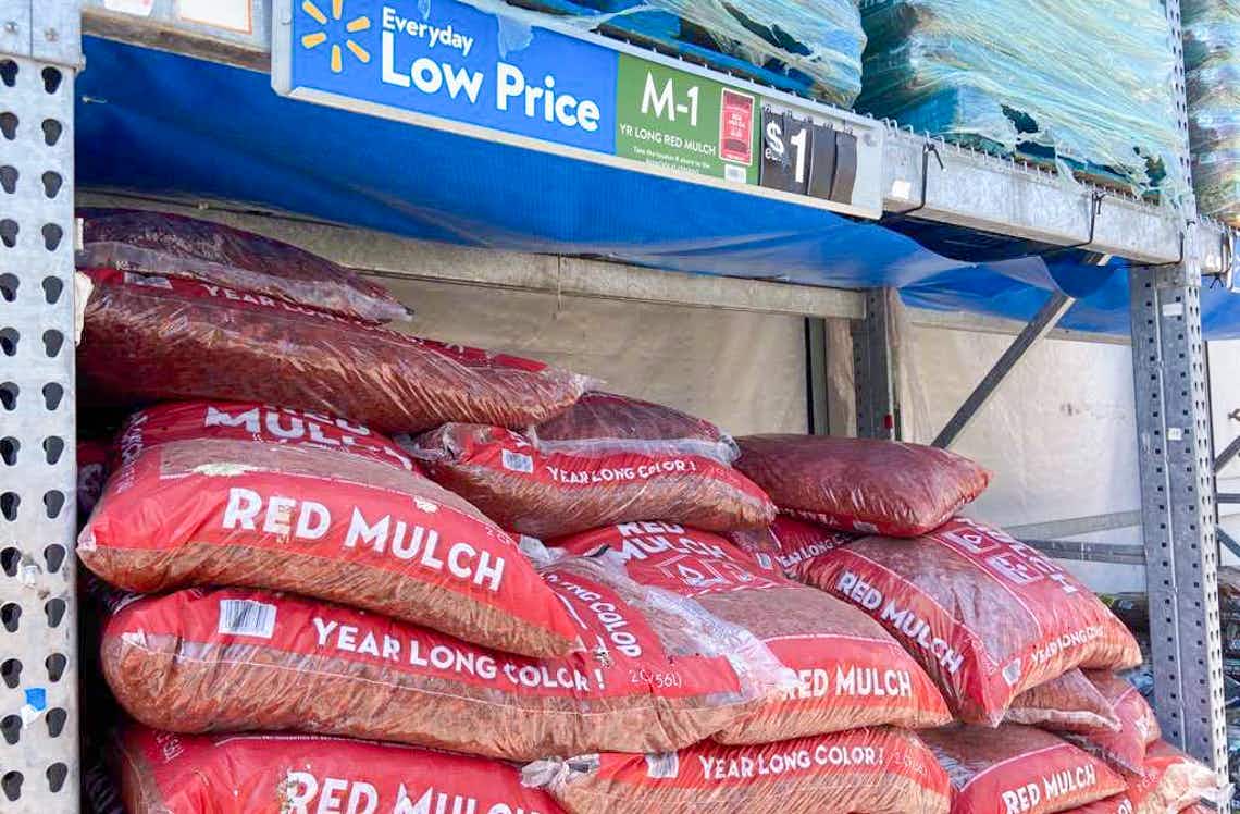 bags of red mulch with walmart price tag above them