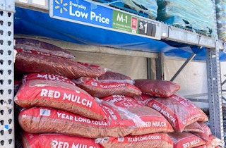 bags of red mulch with walmart price tag above them