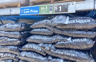 bags of black mulch with walmart price tag above them