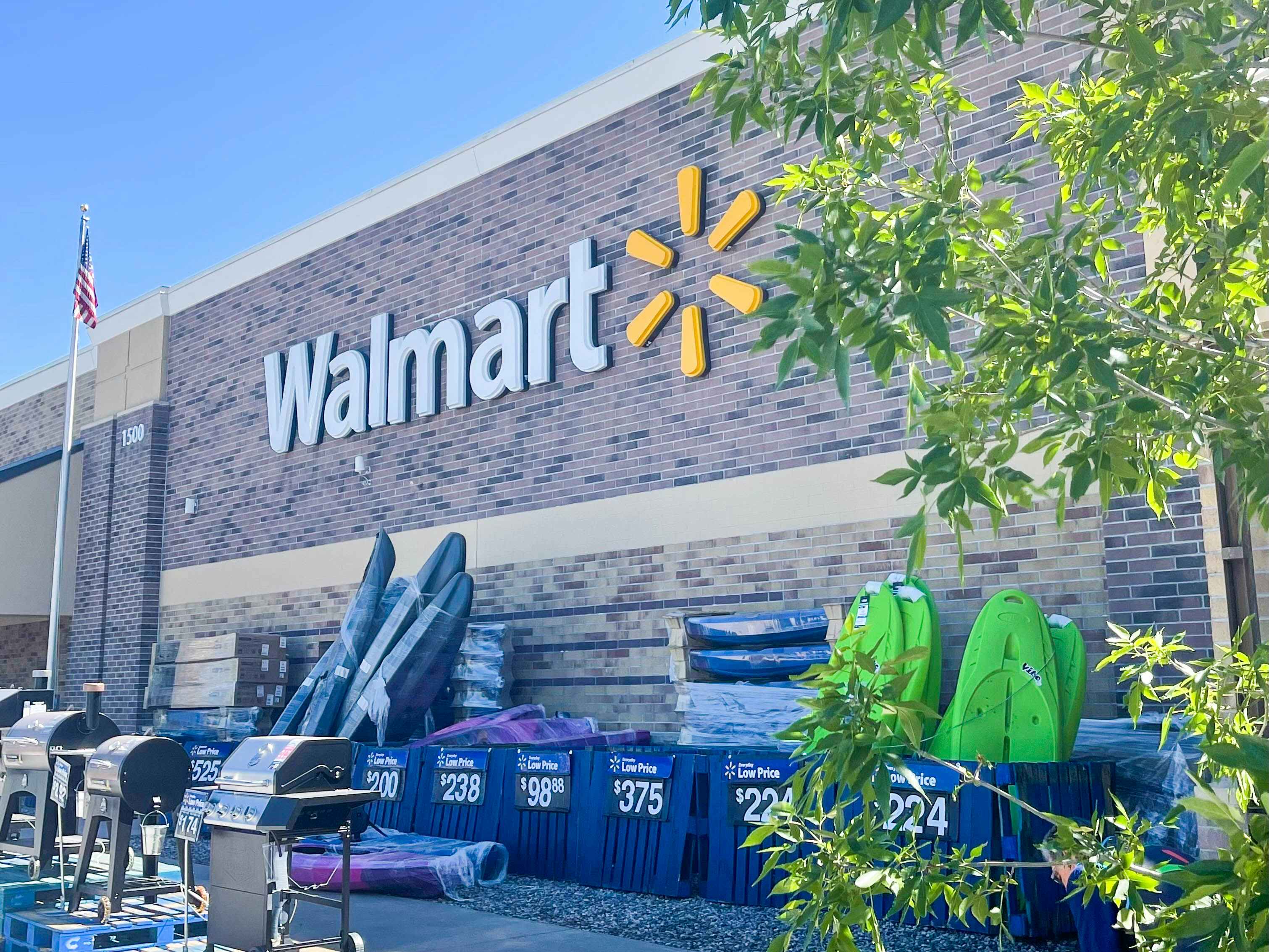A Walmart storefront during the day with products on display outside.