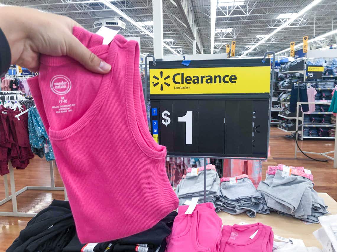 pink wonder nation girl tough tank top held up in front of $1 clearance sign