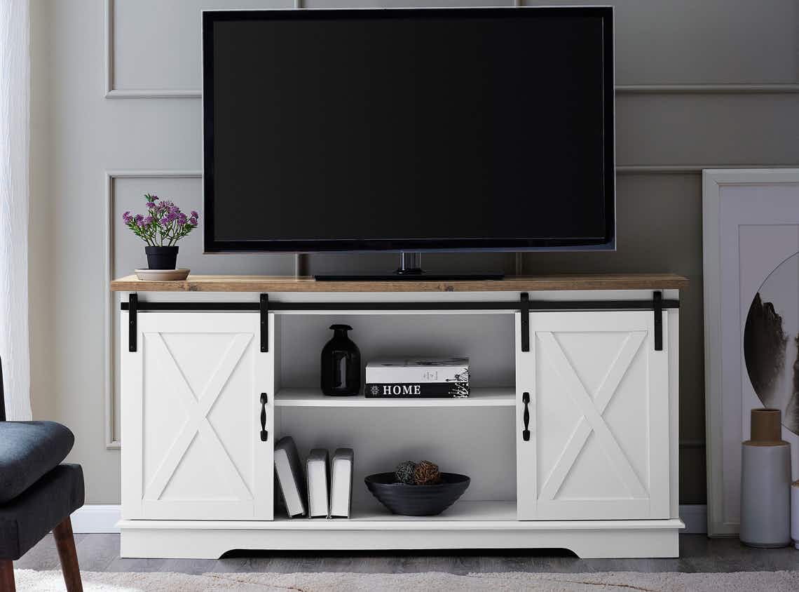 stock photo of woven path farmhouse tv stand with sliding barn style doors staged in living room