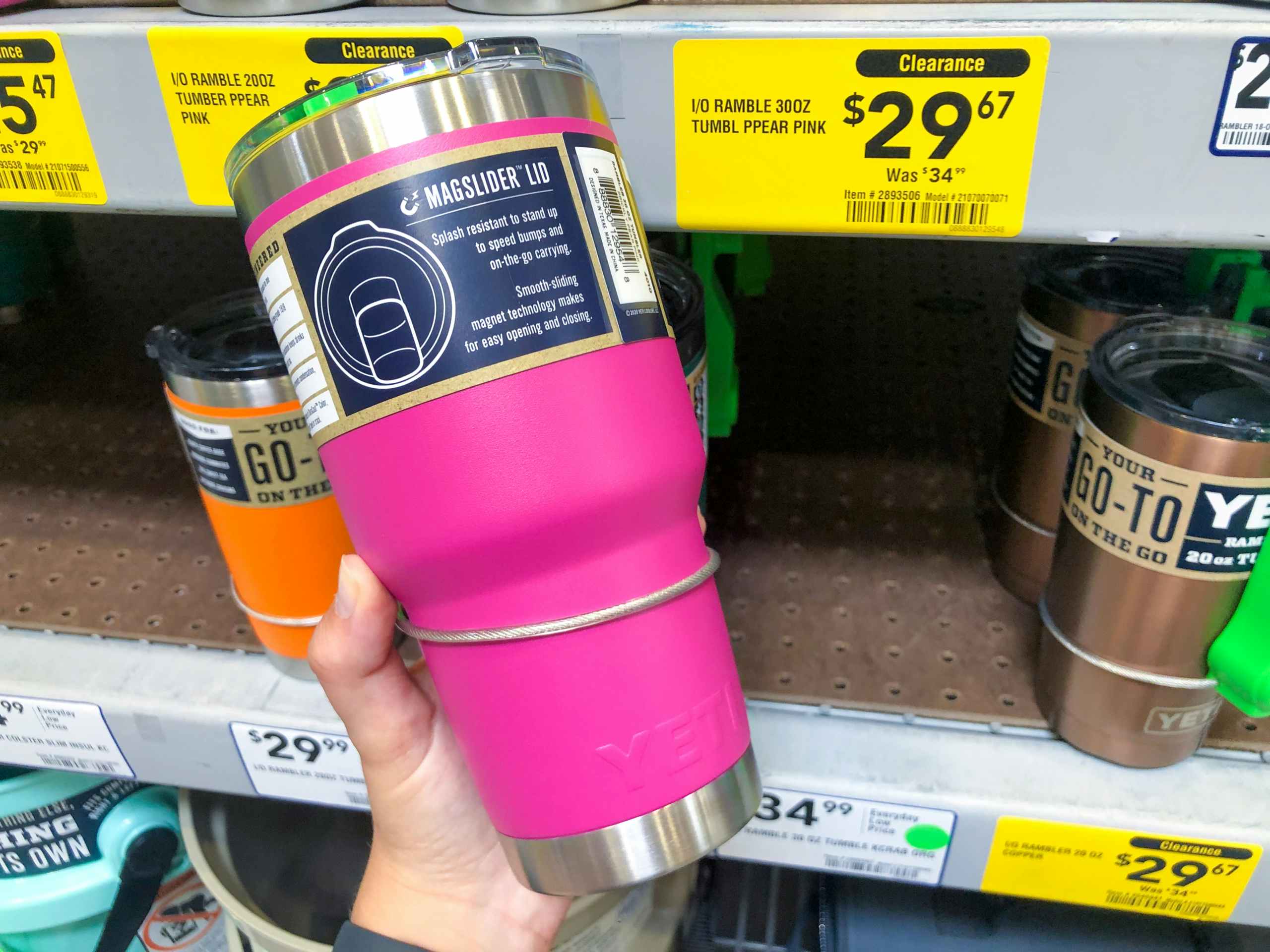 hand holding YETI mug in front of clearance display at Lowe's